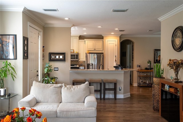 living room with ornamental molding and dark hardwood / wood-style flooring