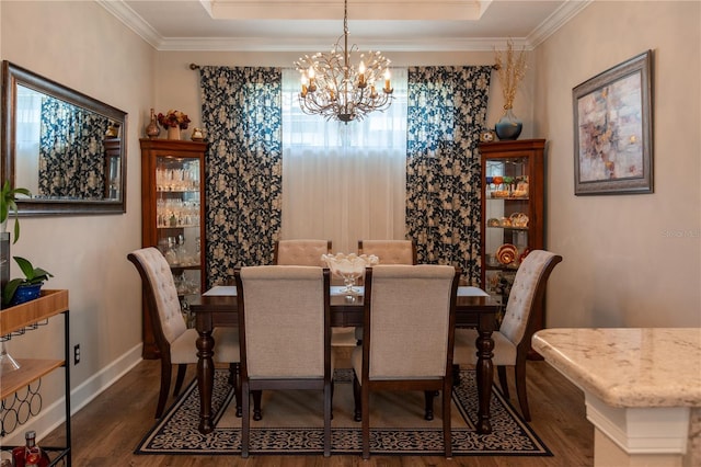 dining space featuring a tray ceiling, crown molding, dark wood-type flooring, and an inviting chandelier