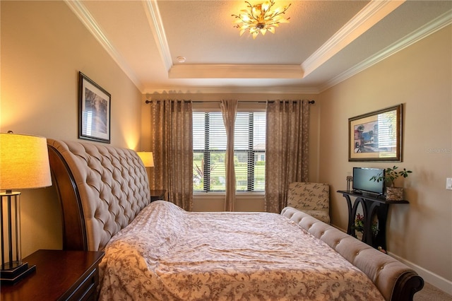 bedroom featuring ornamental molding and a tray ceiling