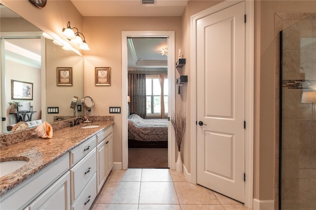 bathroom featuring tile patterned flooring, vanity, ornamental molding, and walk in shower