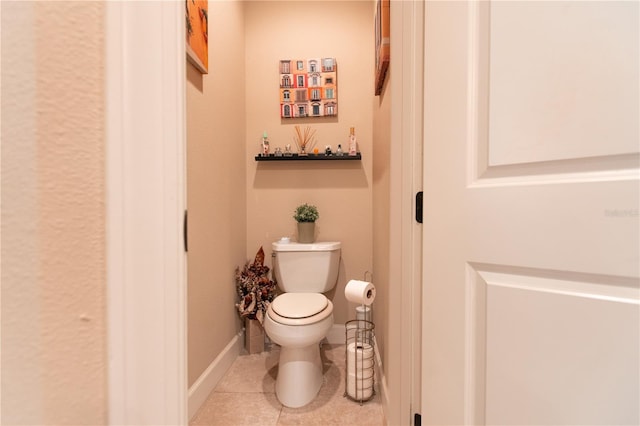 bathroom featuring toilet and tile patterned flooring