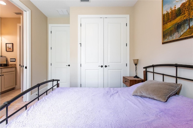 bedroom with connected bathroom and a closet