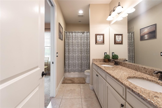 bathroom featuring vanity, toilet, curtained shower, and tile patterned flooring