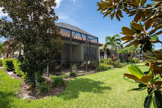 view of yard with a patio area and glass enclosure