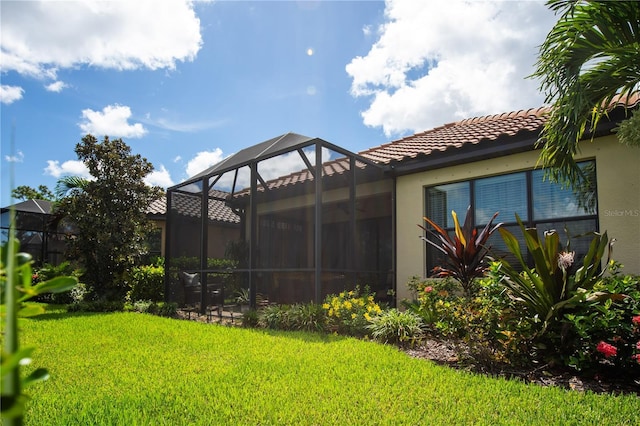 view of yard with glass enclosure