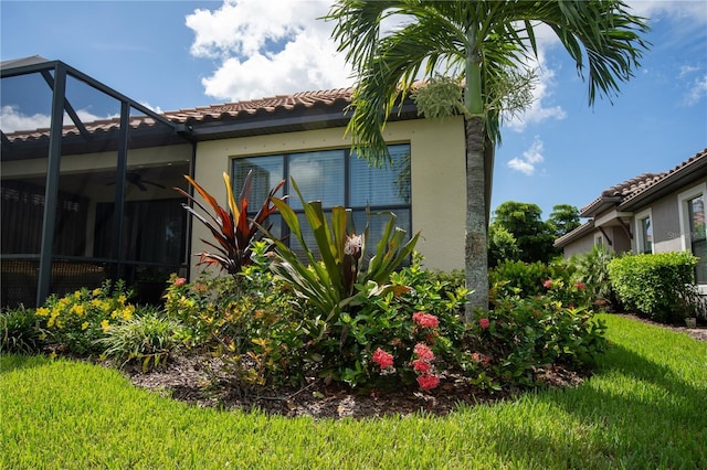 view of property exterior featuring a yard and a lanai