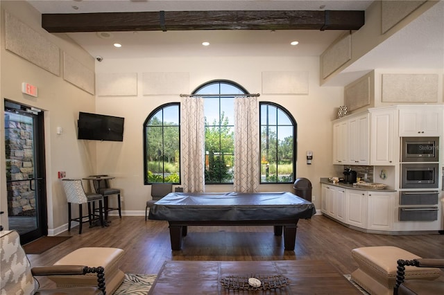 rec room with beam ceiling, dark wood-type flooring, pool table, and a high ceiling