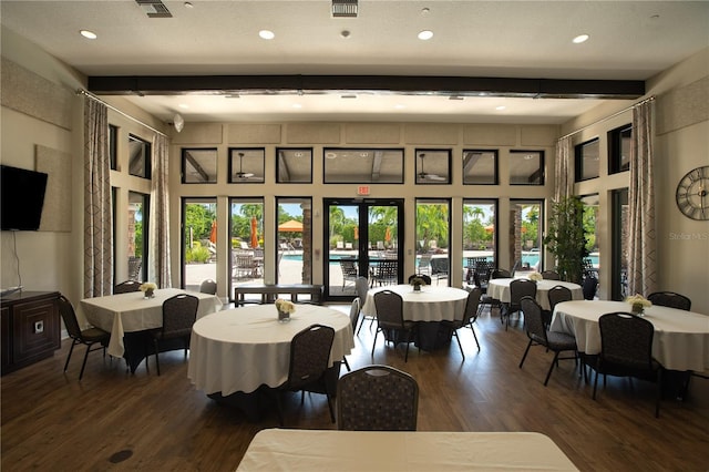 dining room with beamed ceiling, plenty of natural light, dark hardwood / wood-style flooring, and french doors