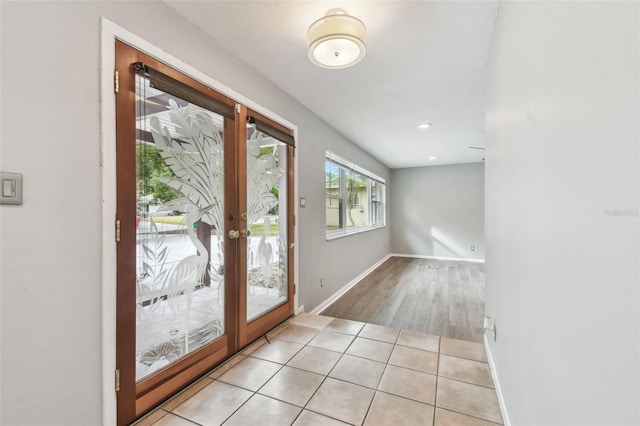 entryway with french doors and light tile patterned floors