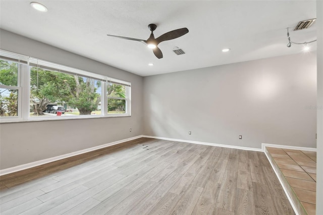 unfurnished room featuring ceiling fan, light hardwood / wood-style flooring, and track lighting