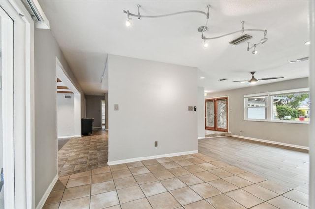 unfurnished room featuring ceiling fan and light tile patterned flooring