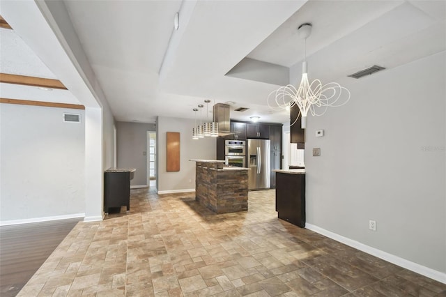 kitchen featuring dark brown cabinetry, appliances with stainless steel finishes, and a chandelier