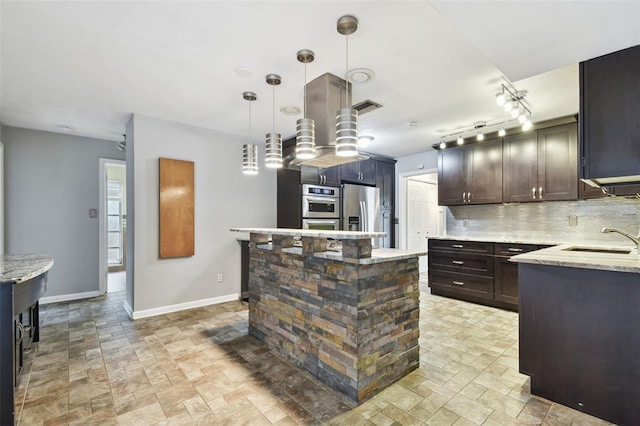 kitchen with sink, a center island, stainless steel appliances, light stone counters, and pendant lighting