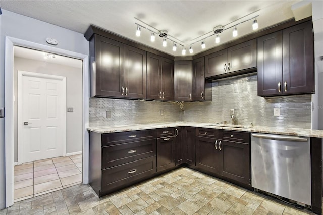 kitchen featuring dark brown cabinetry, stainless steel dishwasher, and sink