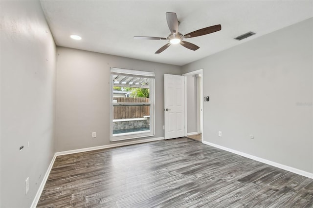 spare room with ceiling fan and dark hardwood / wood-style floors