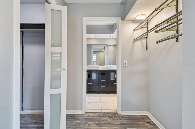 spacious closet with hardwood / wood-style flooring