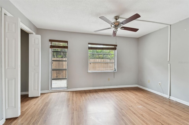 unfurnished bedroom featuring ceiling fan, light hardwood / wood-style floors, and a textured ceiling