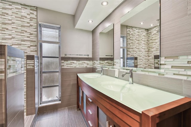 bathroom with vanity and tile walls