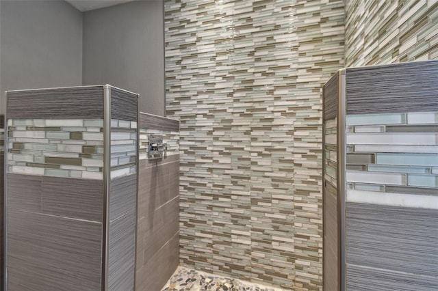 interior details featuring a tile shower