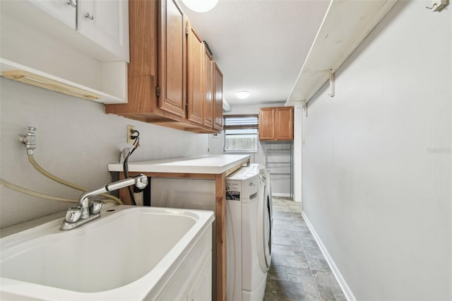 laundry room with cabinets, sink, and washing machine and clothes dryer