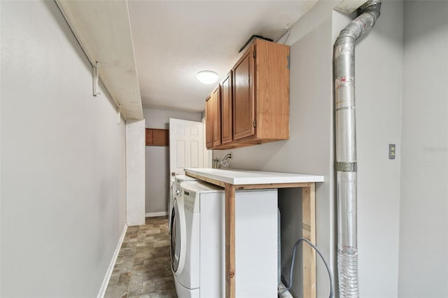 washroom featuring cabinets and washer / clothes dryer