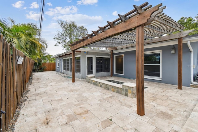 view of patio / terrace with a sunroom and a pergola