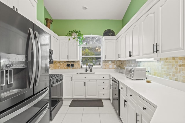 kitchen with white cabinets, black appliances, tasteful backsplash, and sink