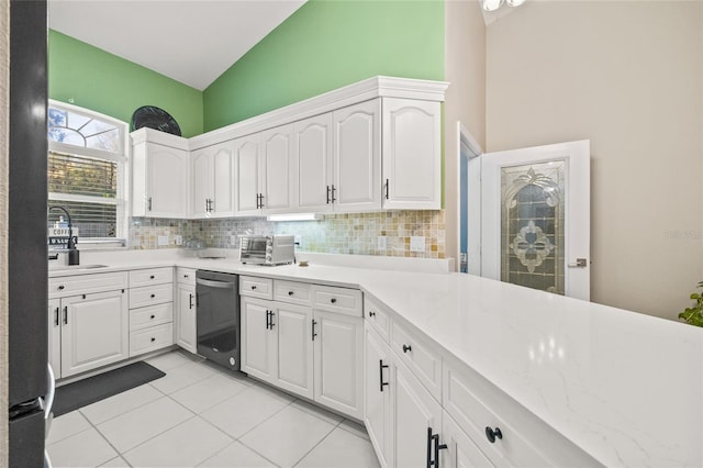 kitchen with white cabinets, stainless steel dishwasher, backsplash, and sink