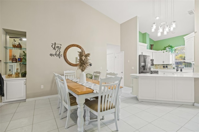 tiled dining area with an inviting chandelier and vaulted ceiling