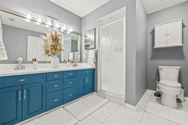 bathroom with toilet, tile patterned floors, vanity, a shower with door, and a textured ceiling