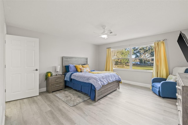 bedroom featuring ceiling fan and light hardwood / wood-style flooring