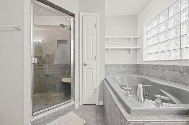 bathroom with separate shower and tub and tile patterned floors