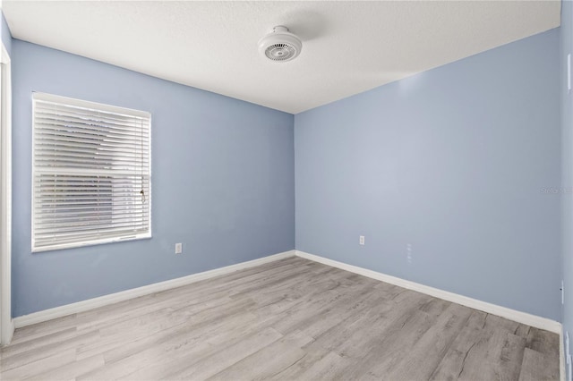 unfurnished room with light wood-type flooring