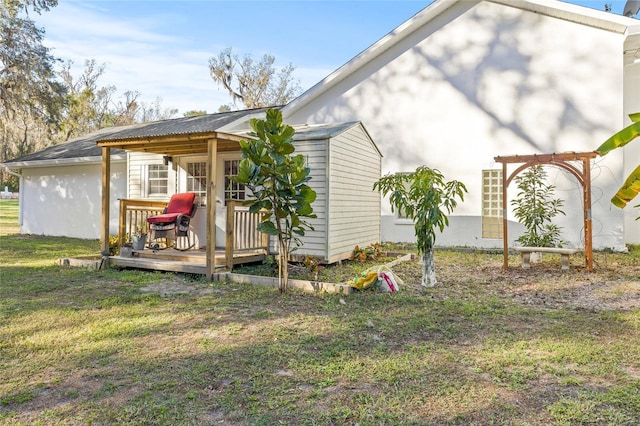 view of side of home featuring a deck and a lawn