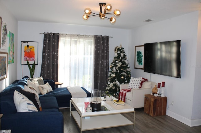 living room featuring dark hardwood / wood-style floors and a chandelier