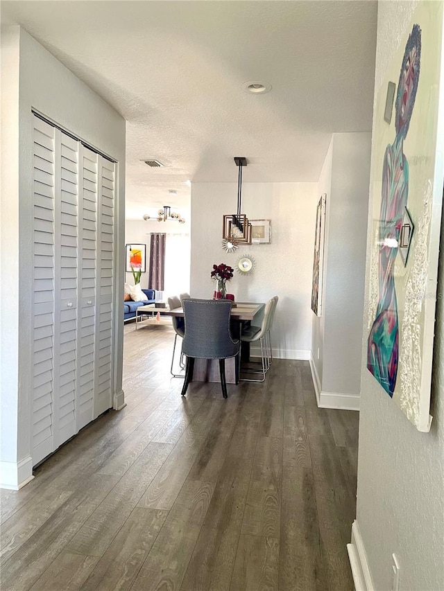 dining room with visible vents, a textured ceiling, baseboards, and dark wood-type flooring