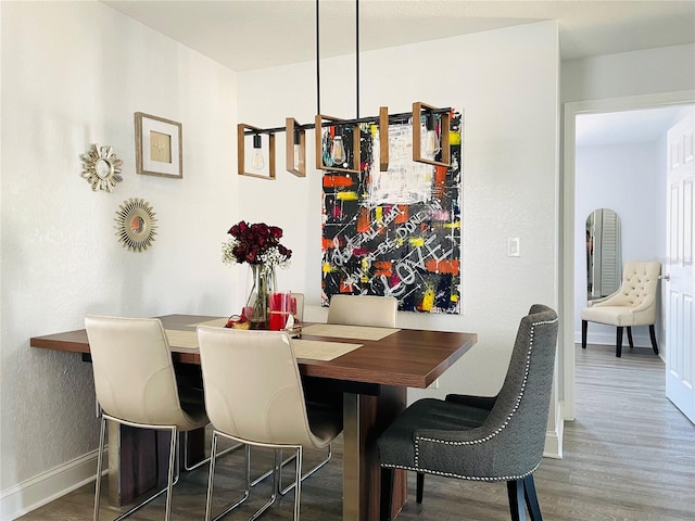 dining area with wood finished floors and baseboards