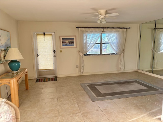 tiled foyer entrance featuring ceiling fan