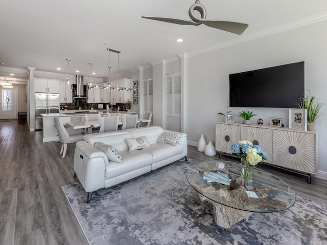 living room with dark hardwood / wood-style floors, ceiling fan, and crown molding