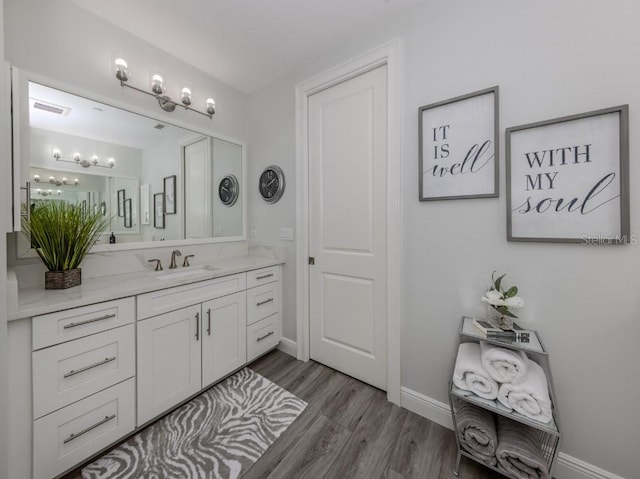 bathroom with vanity and hardwood / wood-style flooring