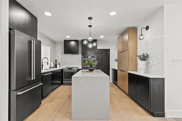 kitchen featuring a kitchen island, backsplash, hanging light fixtures, stainless steel appliances, and light wood-type flooring