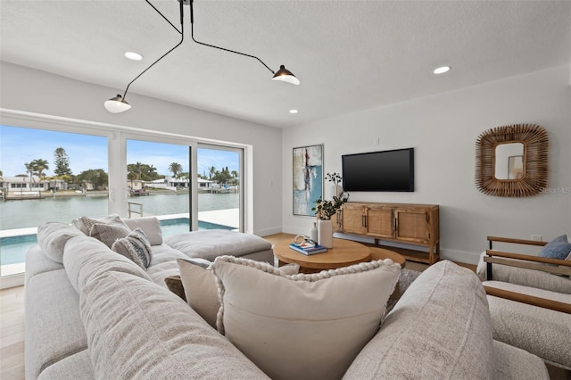 living room with hardwood / wood-style floors and a textured ceiling