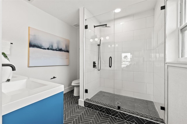 bathroom with vanity, an enclosed shower, and toilet