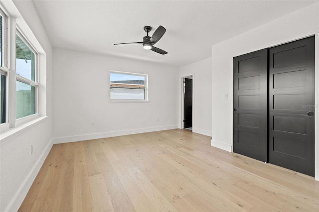 unfurnished bedroom featuring ceiling fan and light wood-type flooring