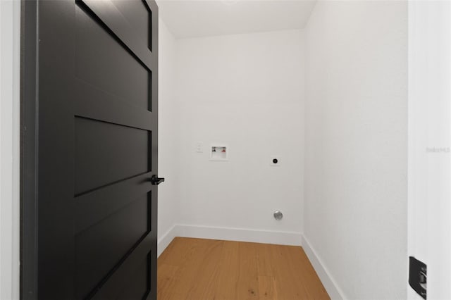 clothes washing area with hardwood / wood-style floors, hookup for a washing machine, and hookup for an electric dryer