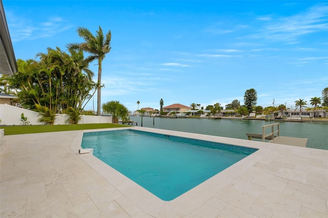 view of swimming pool featuring a patio and a water view