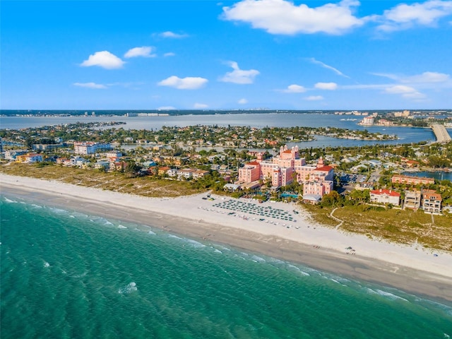 birds eye view of property featuring a water view and a beach view