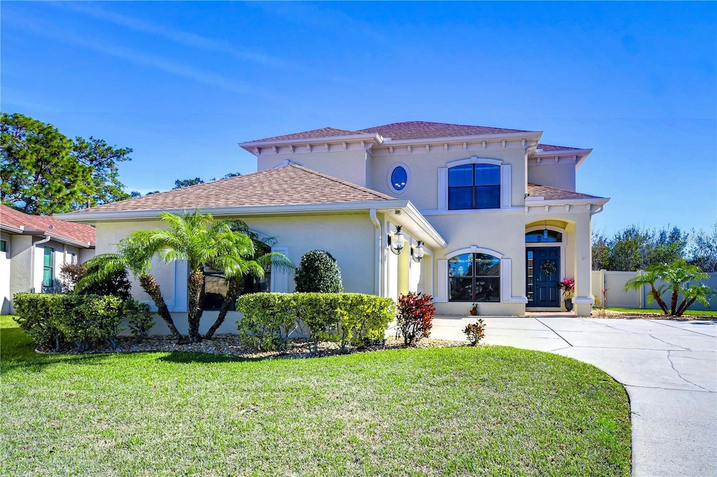 mediterranean / spanish house featuring a front yard