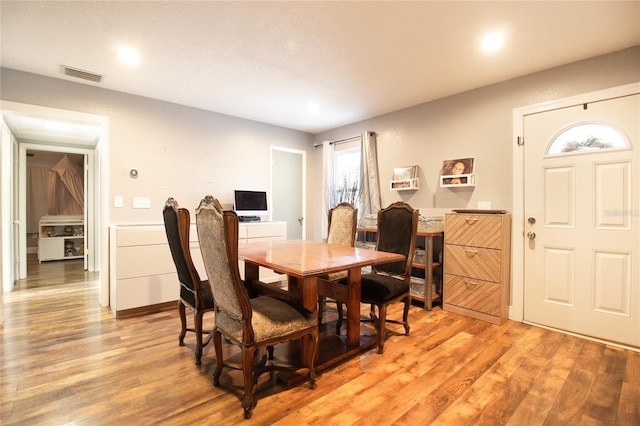 dining area with light hardwood / wood-style floors