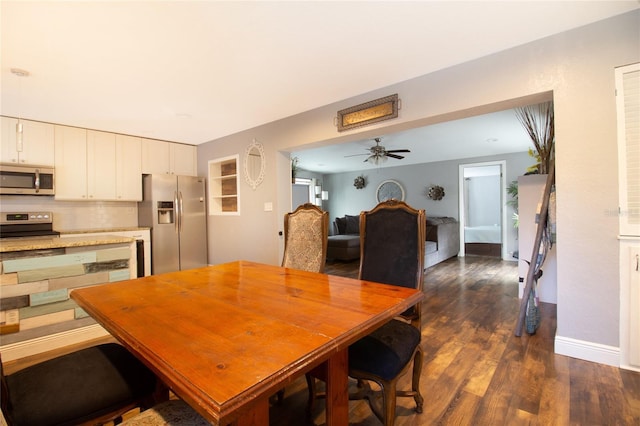 dining area featuring dark hardwood / wood-style floors and ceiling fan